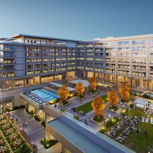 The image shows a modern hotel or apartment complex with a central courtyard featuring a swimming pool, garden, seating areas, and tents for events.