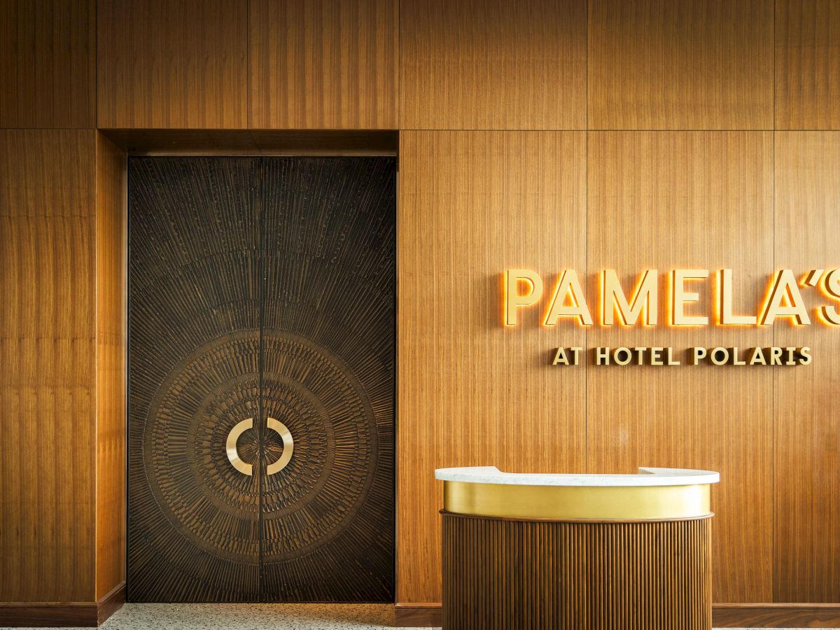 The image shows a sleek wooden interior with a door and a sign reading 