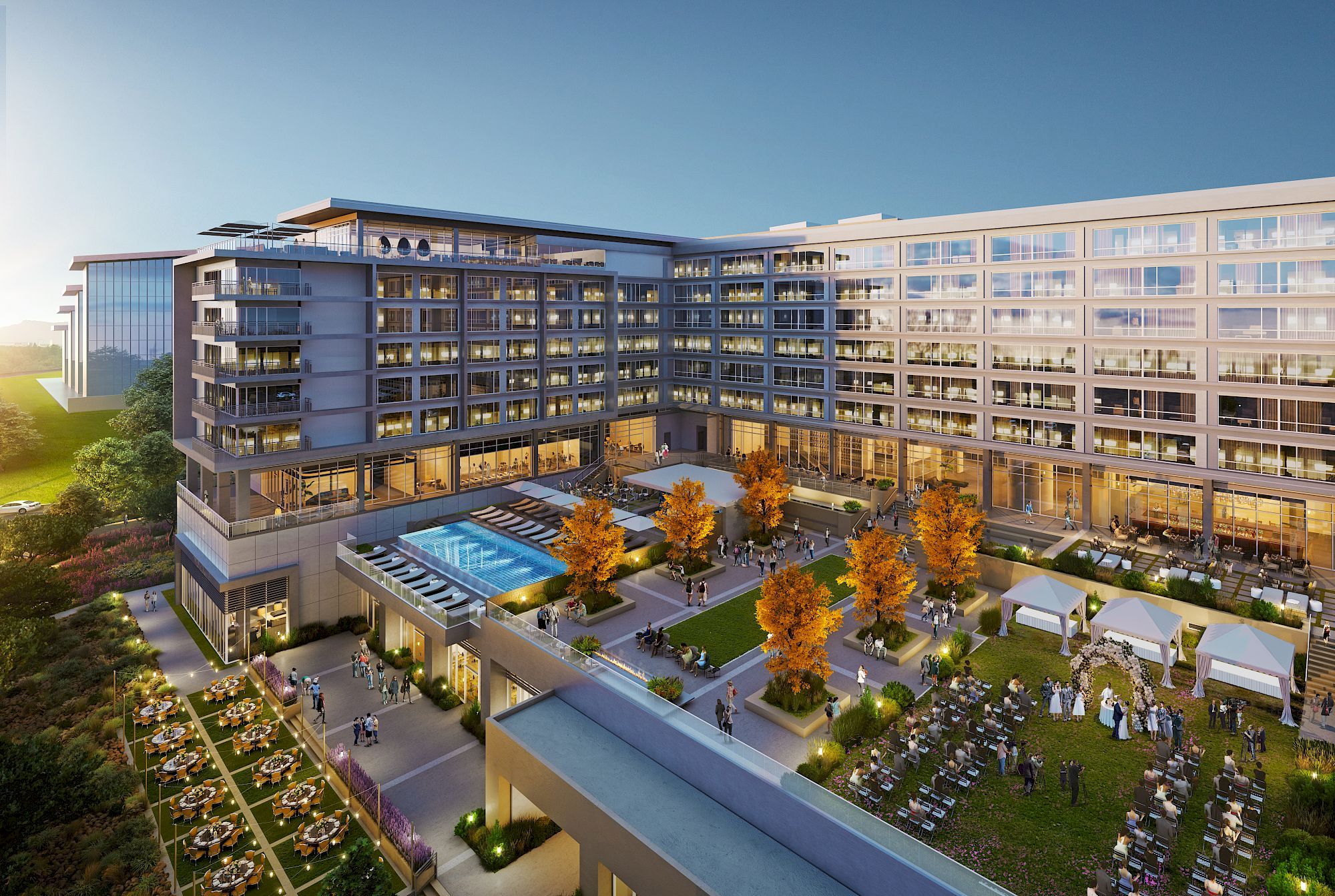 An elevated perspective of a modern hotel or apartment complex featuring a pool, landscaped gardens, and outdoor gathering spaces at sunset.