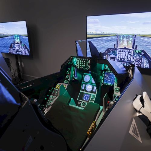 The image shows a flight simulator cockpit with interactive screens displaying a virtual runway environment for pilot training.