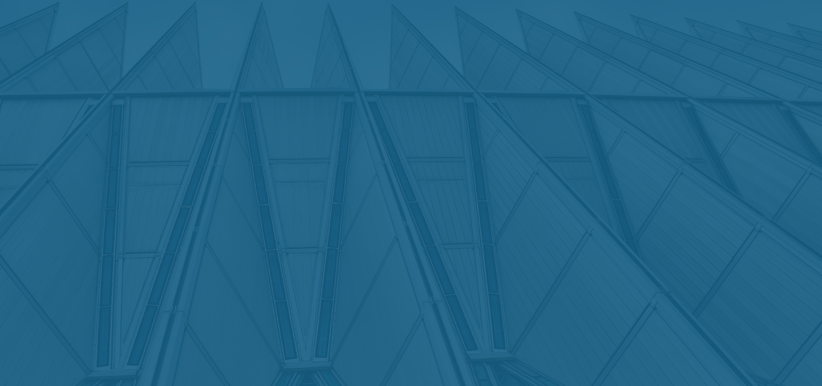 Geometric architectural structure with a series of triangular forms creating a pattern.
